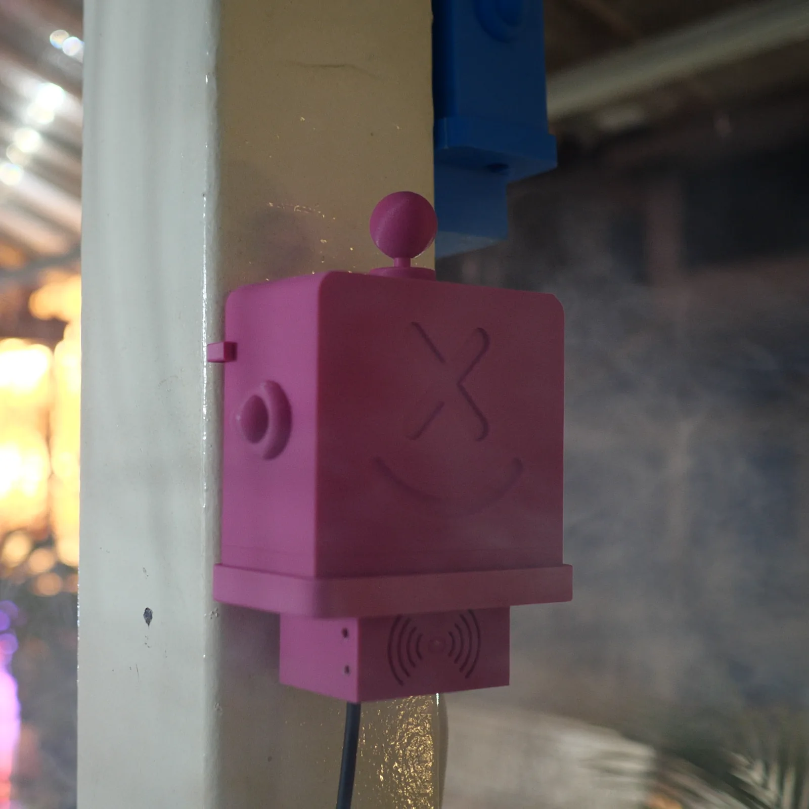 Close view of a magenta Altruist against blurred evening neon